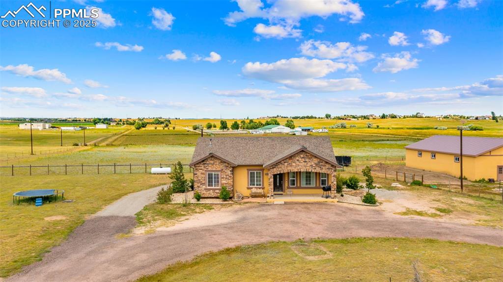 Image 28 of 50: View of front of home featuring dirt driveway, a porch, a rural view, and b