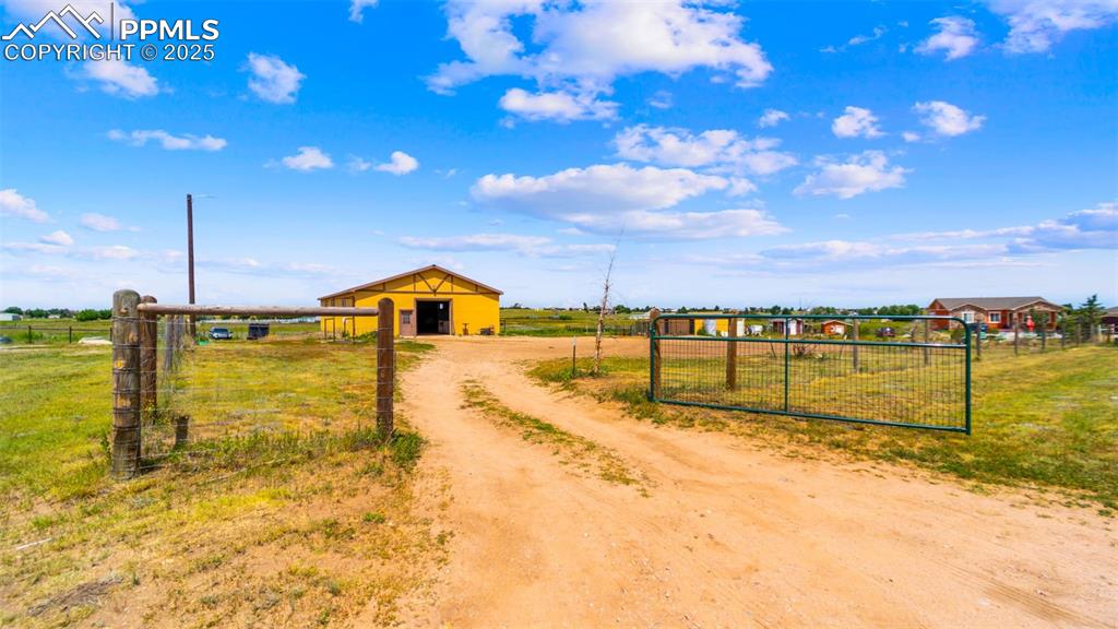 Image 43 of 50: View of dirt / gravel driveway featuring a view of rural / pastoral area an
