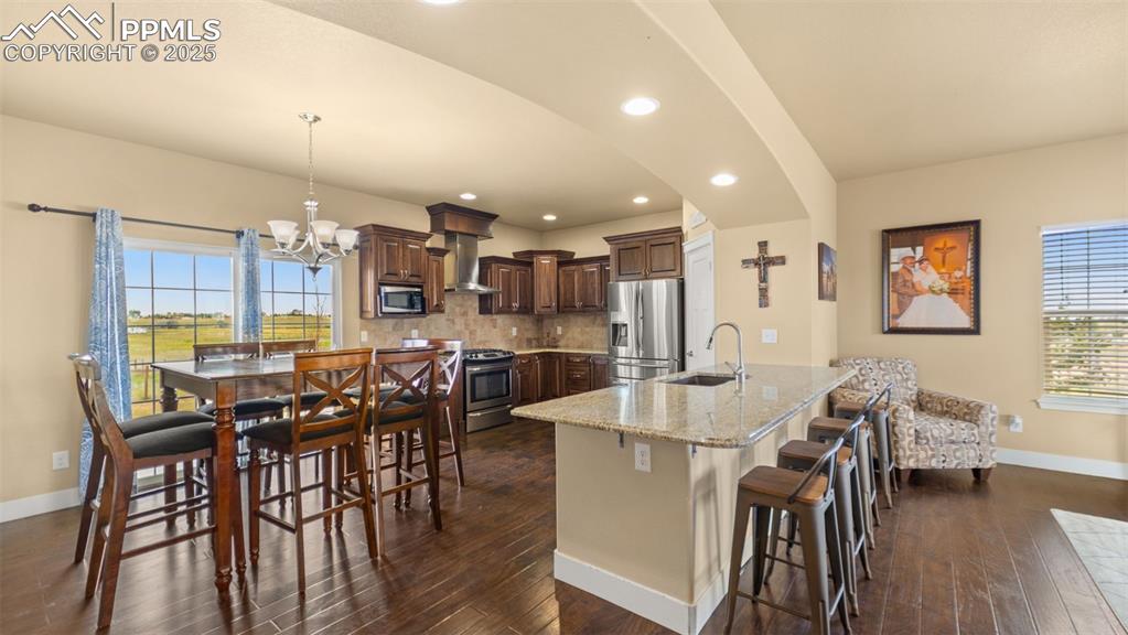 Image 5 of 50: Kitchen with healthy amount of natural light, backsplash, stainless steel a