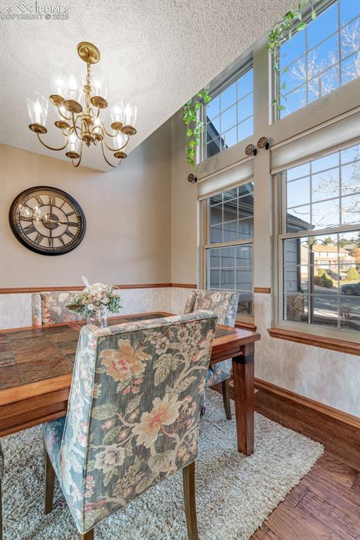 Image 12 of 41: Dining room drawing light from 2-story windows. 