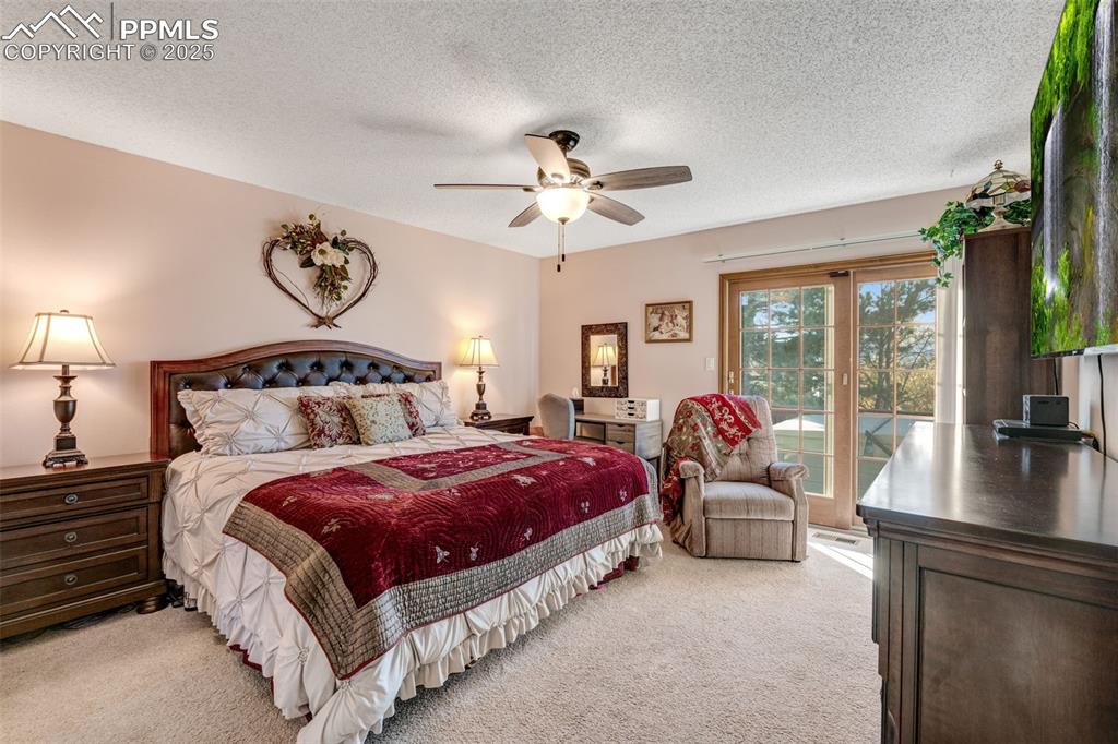Image 13 of 41: Primary bedroom with private deck and hot tub.