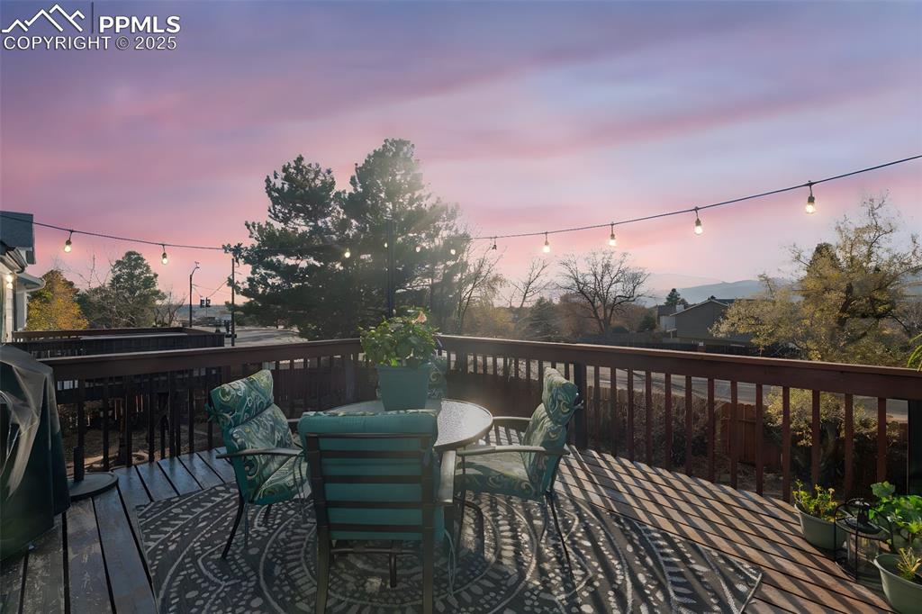 Image 28 of 41: Wooden terrace featuring outdoor dining space and grilling area