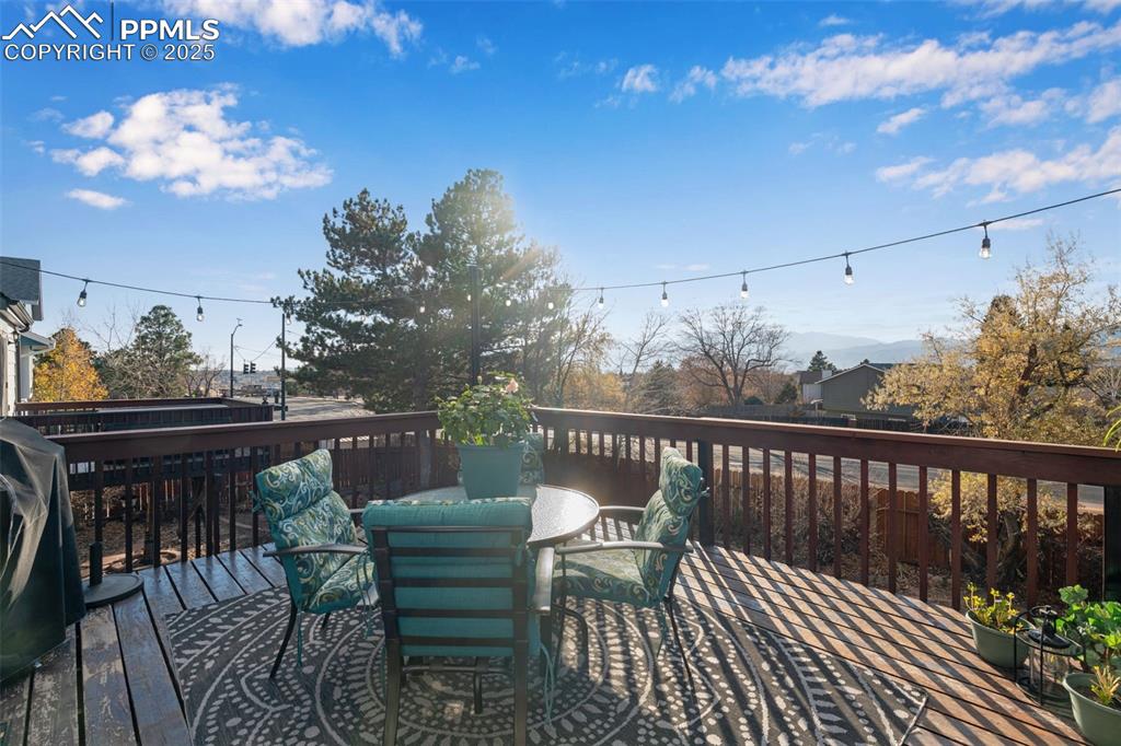 Image 7 of 41: Wood deck featuring outdoor dining space and incredible views of Pikes Peak