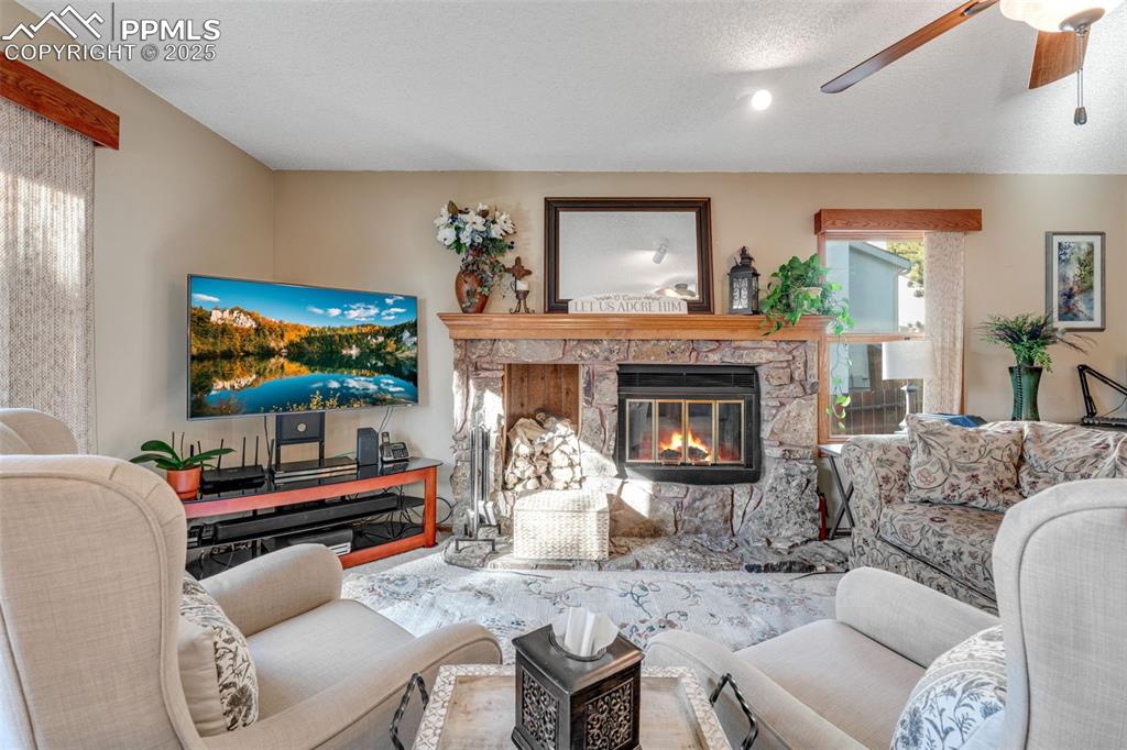 Image 9 of 41: Cozy living room with wood burning fireplace. 