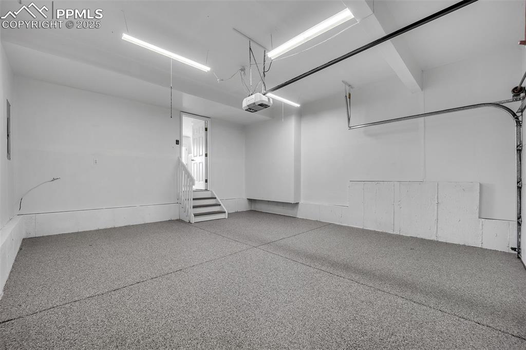 Image 19 of 43: Garage with epoxy floors