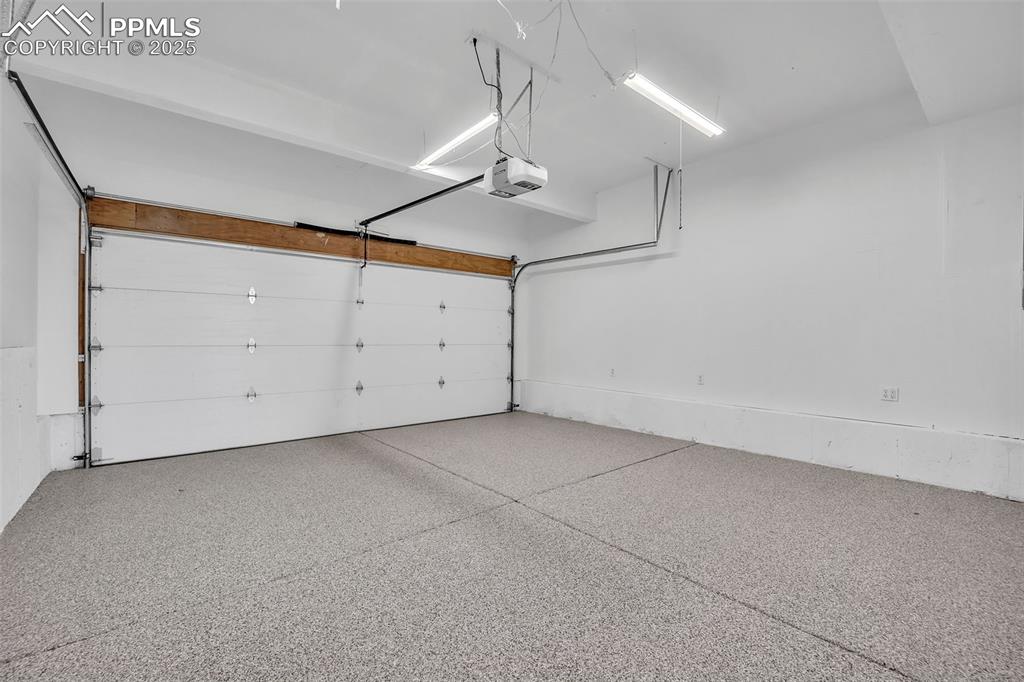 Image 20 of 43: Garage with epoxy floors