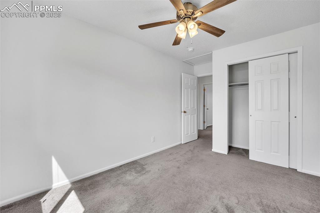 Image 24 of 43: Unfurnished bedroom featuring carpet floors, a closet, and a ceiling fan