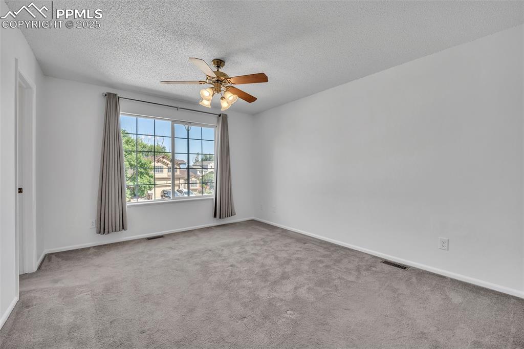 Image 25 of 43: Spare room featuring light colored carpet, a textured ceiling, and ceiling
