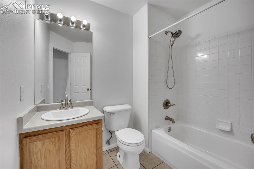 Image 30 of 43: Full bathroom featuring shower / bathtub combination, light tile patterned