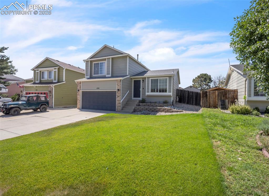 Image 33 of 43: View of front facade featuring an attached garage and concrete driveway