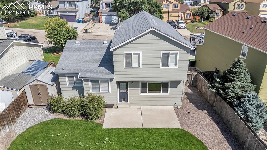 Image 39 of 43: Rear view of property featuring a residential view, a patio area, roof with