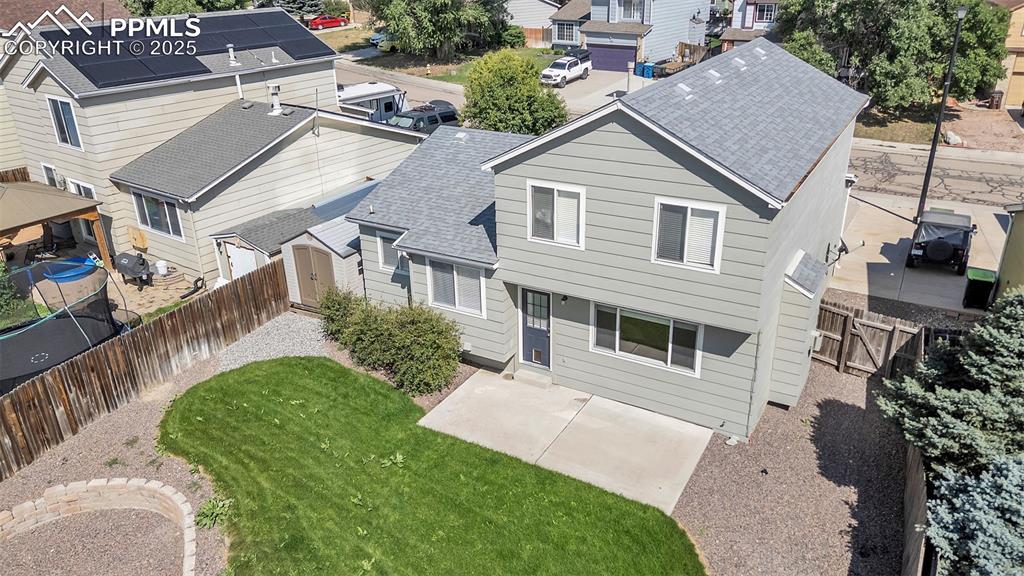 Image 40 of 43: Rear view of property featuring a fenced backyard, roof with shingles, a re