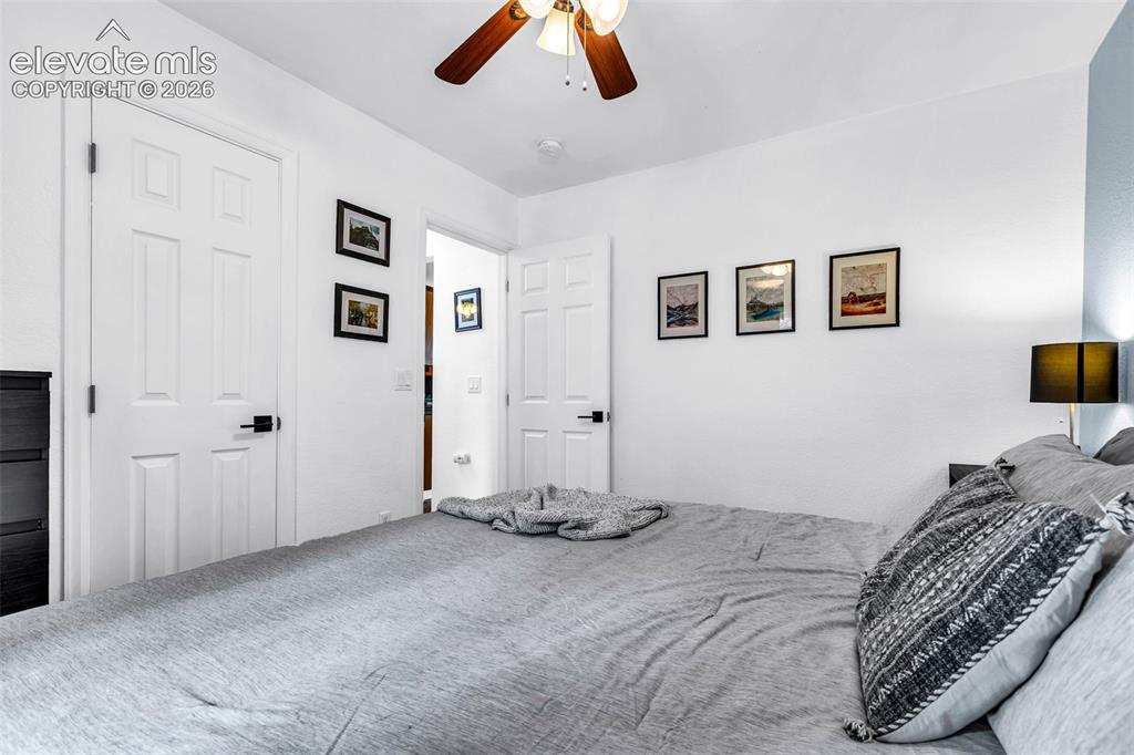 Image 15 of 37: Bedroom with white walls and a light blue accent wall