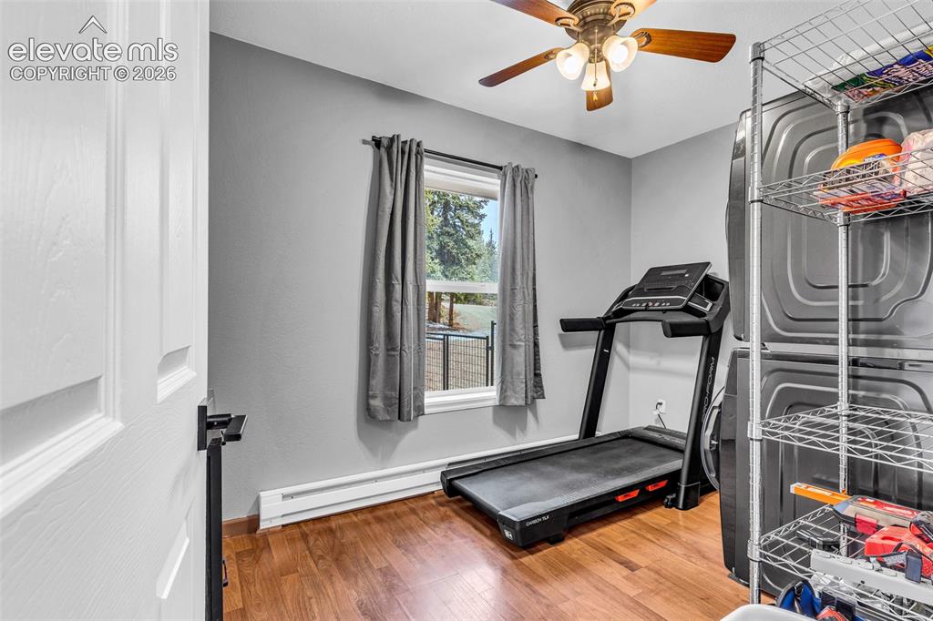 Image 17 of 37: 2nd bedroom with wood-finish flooring, a window with exterior visibility, a