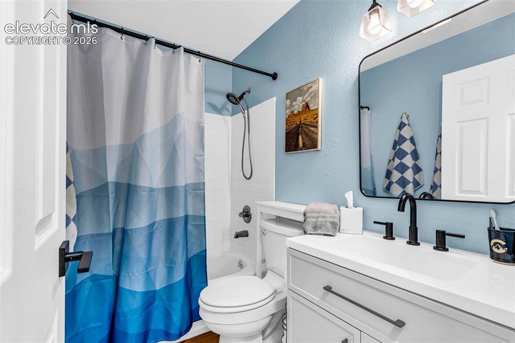 Image 19 of 37: Bathroom featuring a white vanity with an integrated sink, matte black fauc