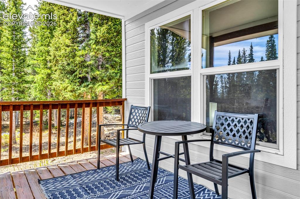 Image 23 of 37: Private outdoor deck with natural wood railing and wood-finish flooring
