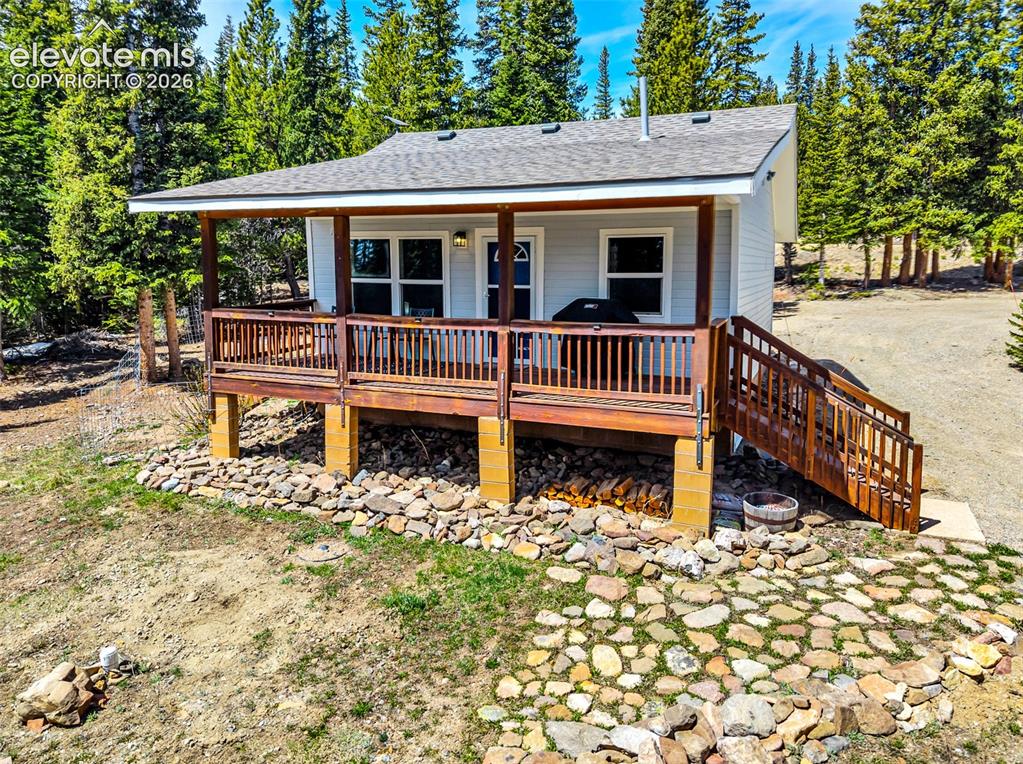Image 3 of 37: Elevated deck with wooden railings and staircase