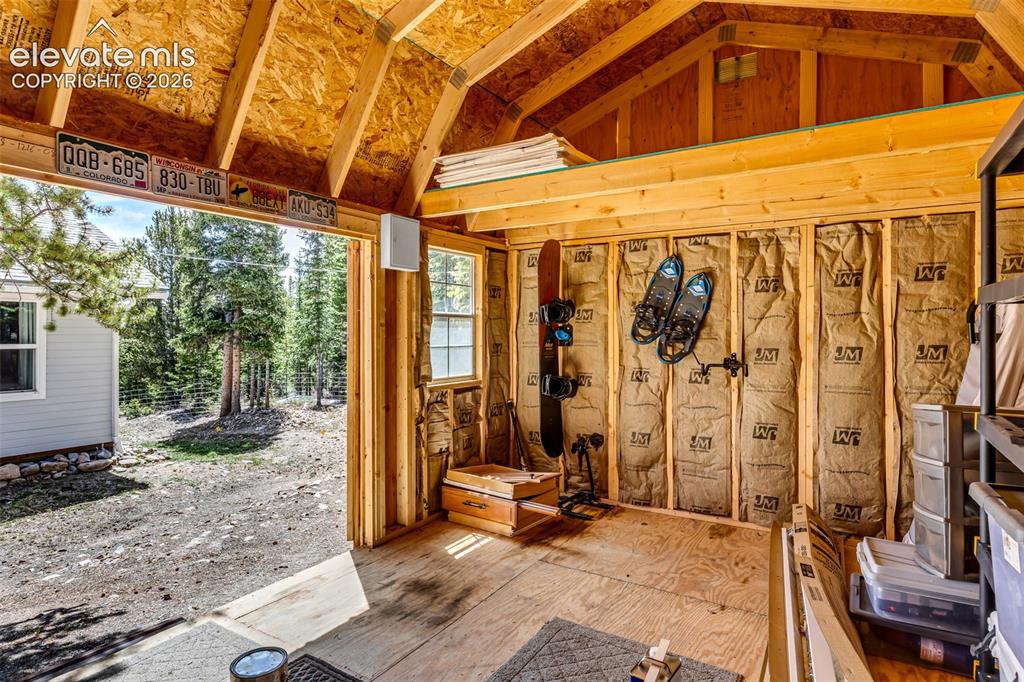 Image 31 of 37: Interior, insulated, shed space featuring exposed wood, framing, a vaulted 