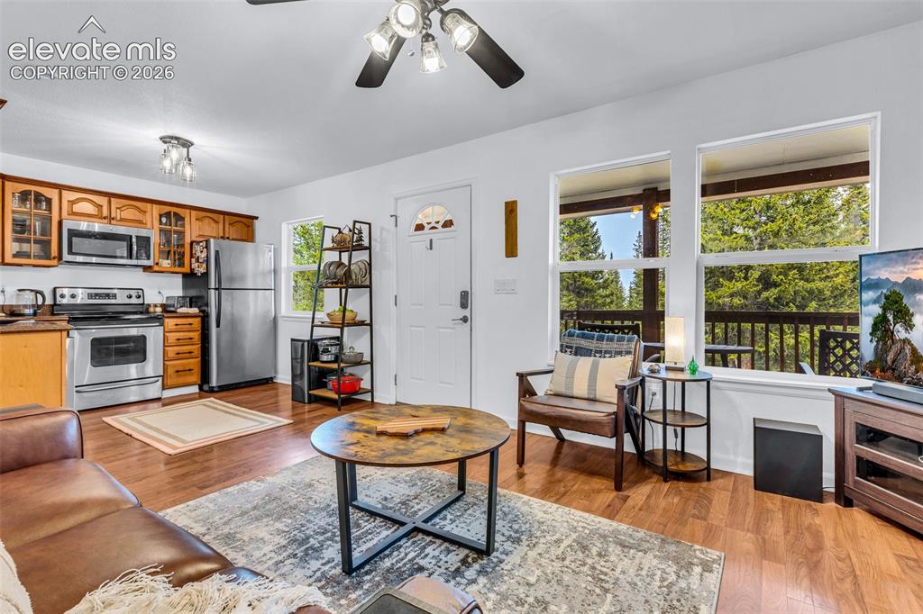 Image 9 of 37: Open-concept living area featuring wood-finish flooring throughout
