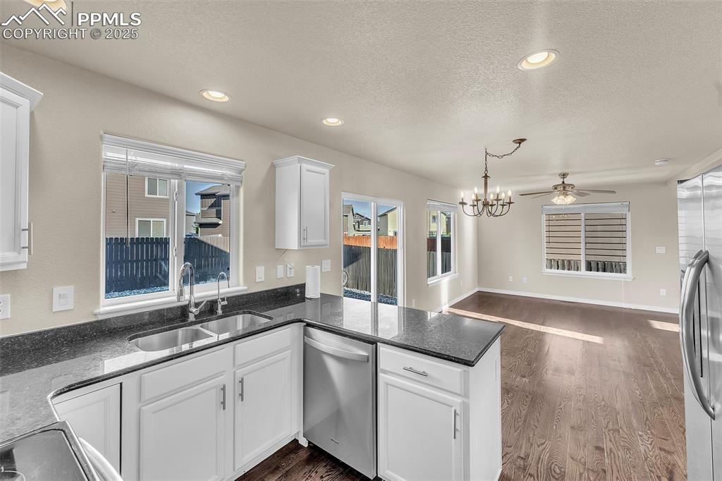Image 14 of 28: Kitchen with appliances with stainless steel finishes, a textured ceiling, 