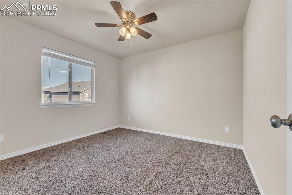 Image 16 of 28: Carpeted empty room featuring ceiling fan and baseboards