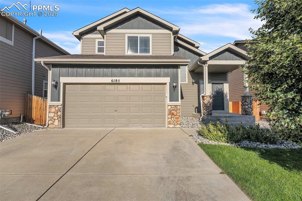 Image 2 of 28: Craftsman-style home featuring board and batten siding, stone siding, drive
