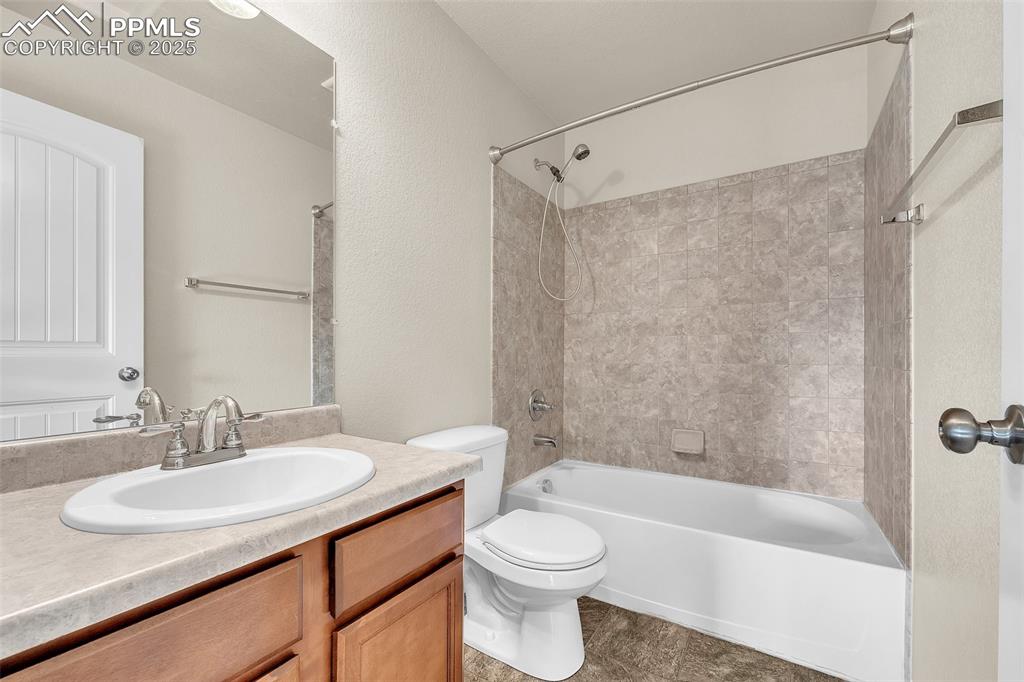 Image 26 of 28: Bathroom featuring washtub / shower combination and vanity