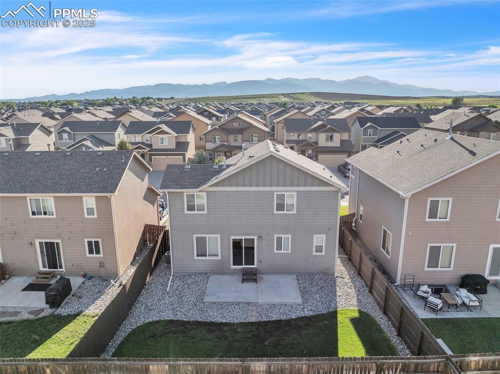 Image 28 of 28: Aerial perspective of suburban area featuring mountains