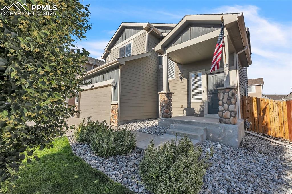 Image 3 of 28: View of property exterior featuring board and batten siding and stone sidin