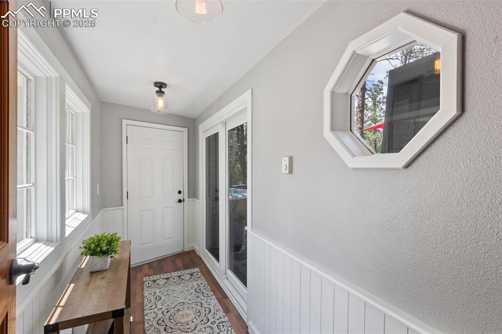 Image 14 of 50: Breezeway/mudroom connecting the two car garage to the main house