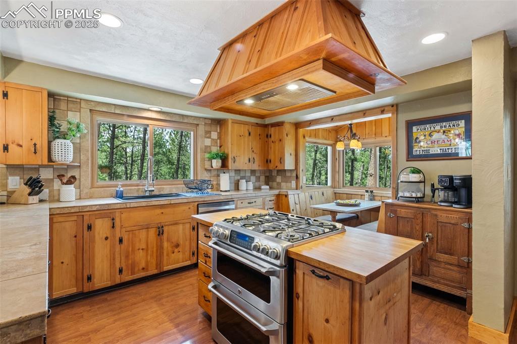 Image 18 of 50: Kitchen with gas stove, plenty of natural light, and recessed lighting