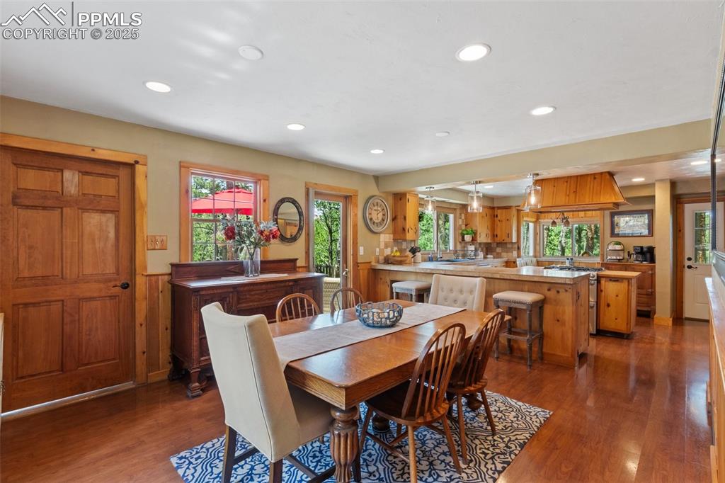 Image 21 of 50: Dining area with wood floors and recessed lighting