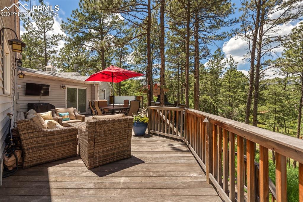 Image 45 of 50: Brazilian hardwood deck with outdoor dining space and an outdoor hangout ar