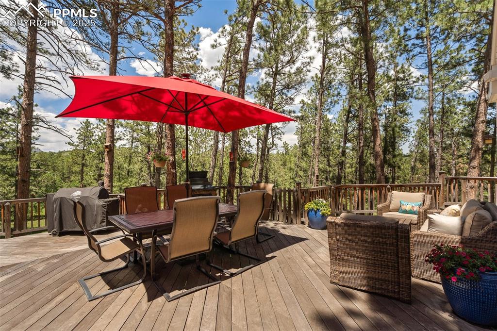 Image 46 of 50: Brazilian hardwood deck with outdoor lounge area, outdoor dining area, and 