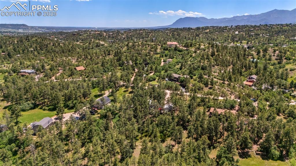 Image 7 of 50: Aerial view of property and surrounding area with mountains