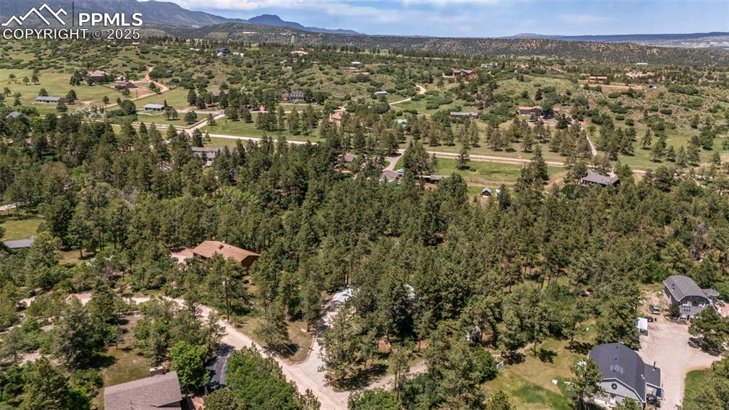 Image 9 of 50: Aerial view of property and surrounding area with mountains