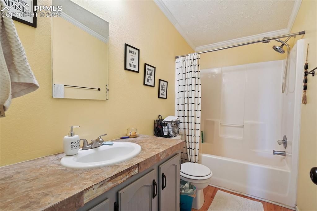 Image 35 of 48: Full bathroom featuring ornamental molding, shower / bathtub combination wi