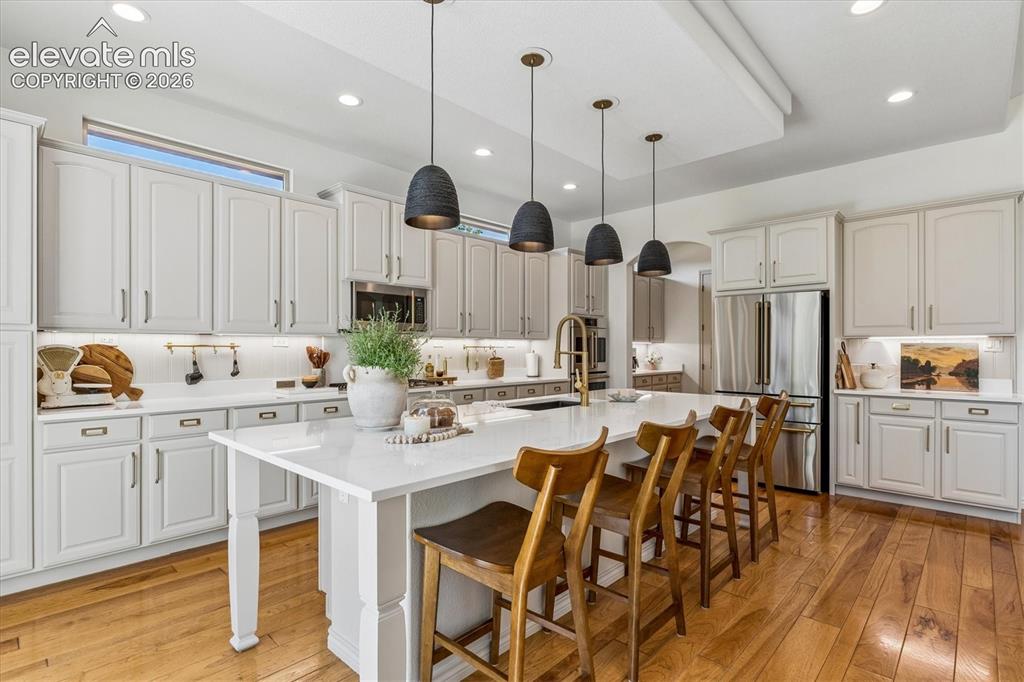 Image 14 of 50: Spacious kitchen featuring an expansive center island and stainless steel a