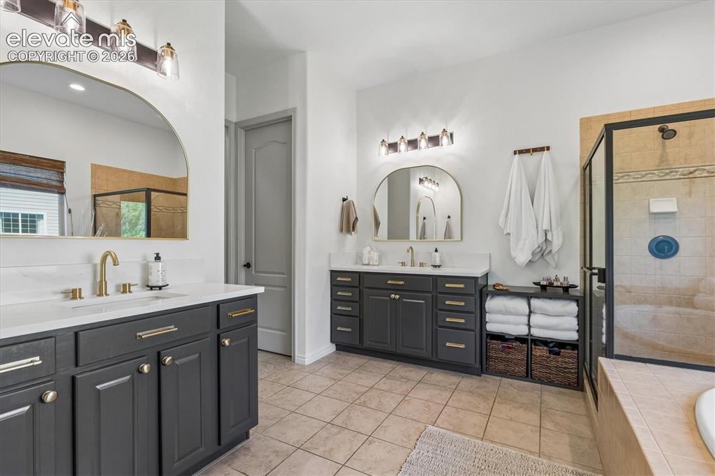 Image 21 of 50: Primary bathroom with dual vanities