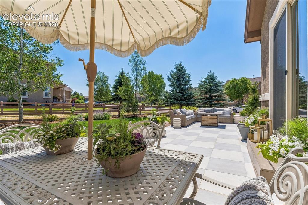 Image 39 of 50: Expansive outdoor patio featuring a checkerboard-patterned tile surface