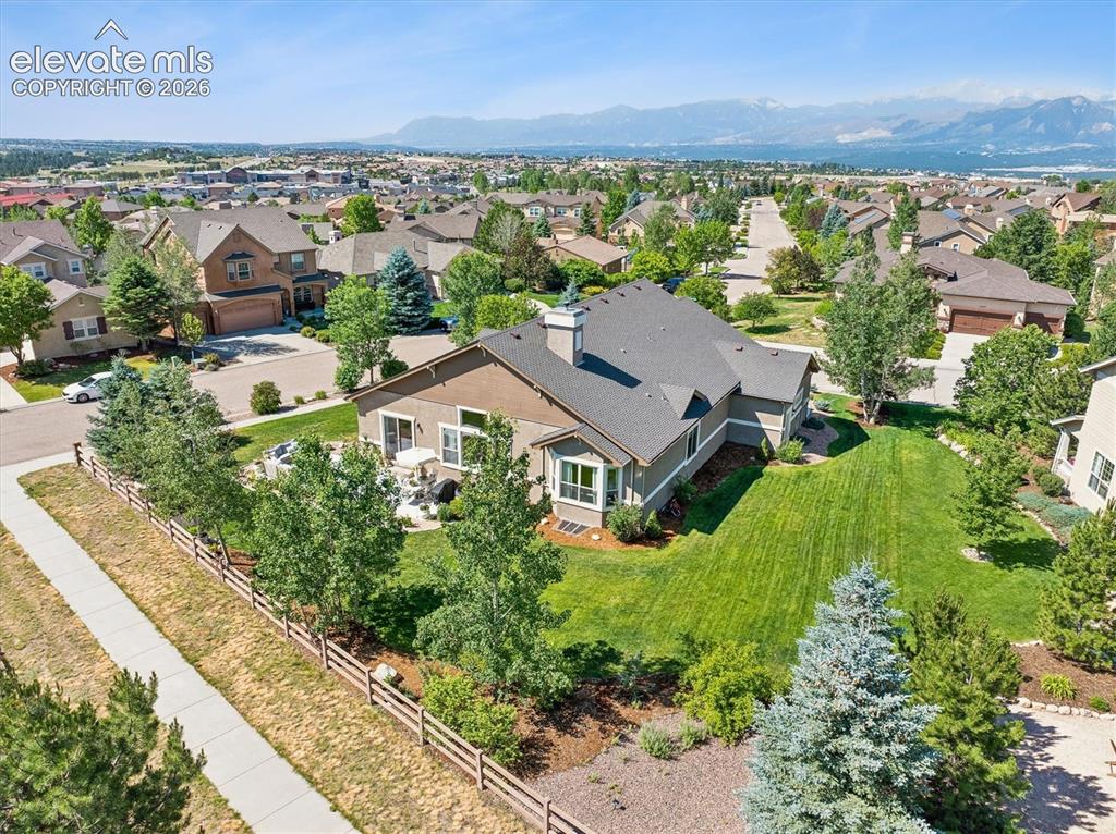 Image 44 of 50: Spacious property featuring a large backyard with a manicured lawn, mature
