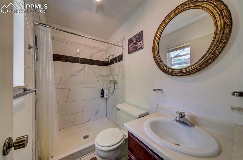 Image 29 of 44: Full bathroom with vanity and a stall shower