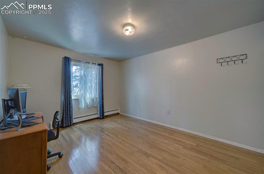 Image 33 of 44: Office area featuring light wood-style flooring and baseboards