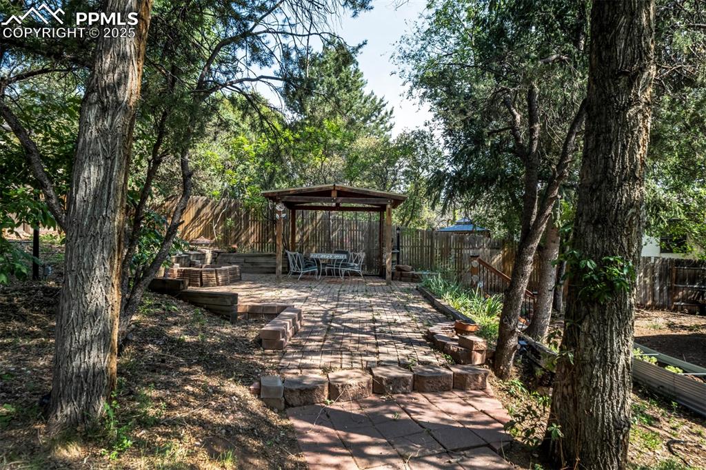 Image 39 of 44: Fenced backyard featuring a patio area
