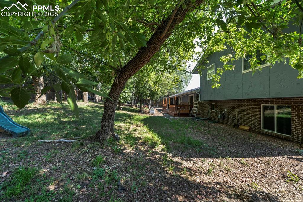 Image 40 of 44: View of green lawn with a wooden deck