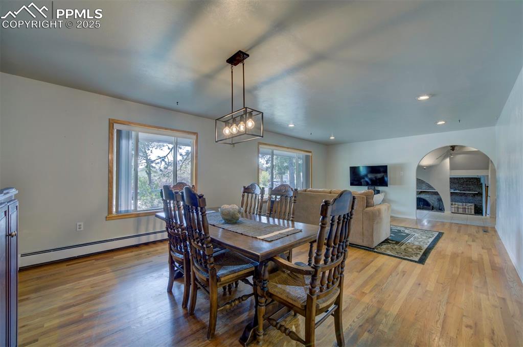 Image 9 of 44: Dining space featuring a baseboard heating unit, light wood finished floors