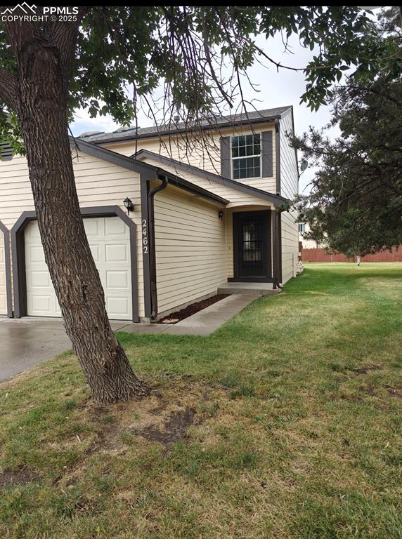 Caption: View of front facade with an attached garage and driveway