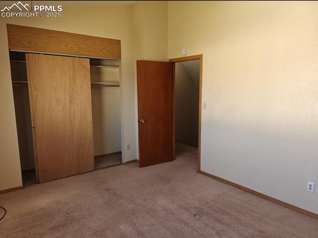 Image 10 of 17: Unfurnished bedroom with carpet flooring and a closet
