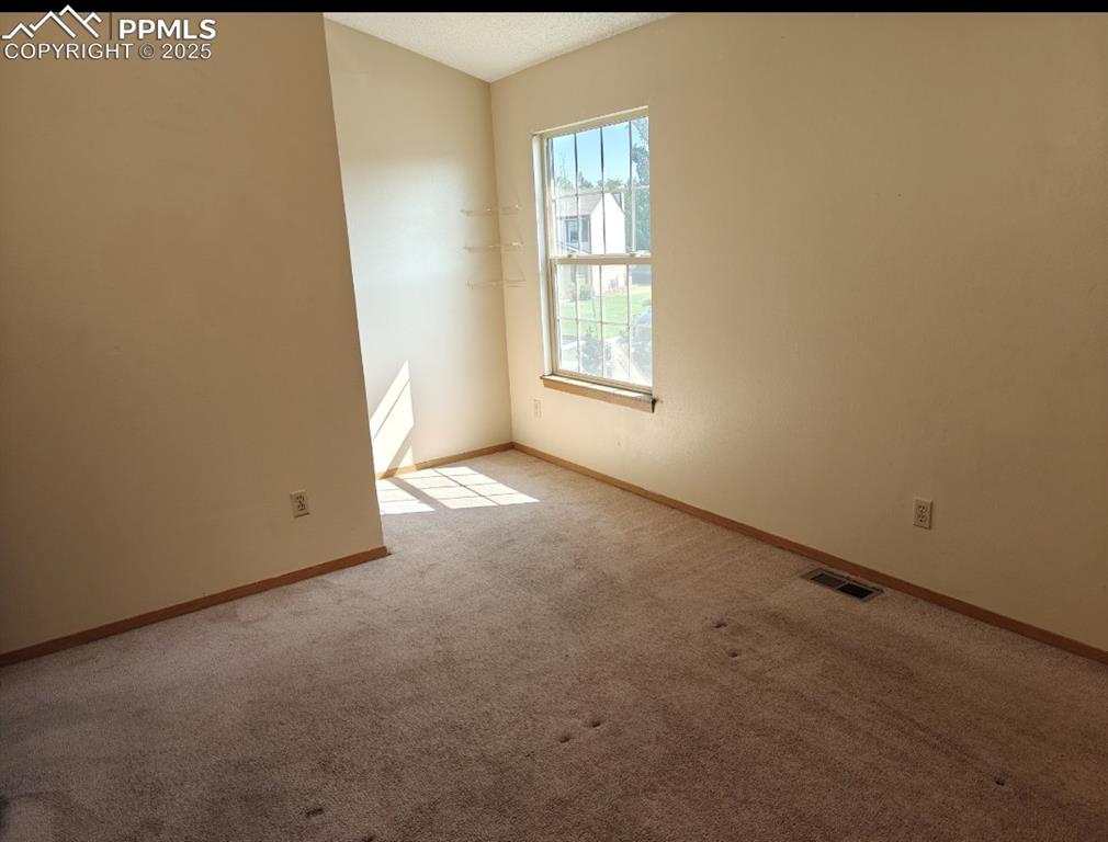 Image 11 of 17: Spare room with carpet floors and baseboards