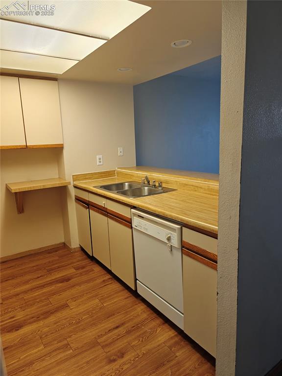 Image 5 of 17: Kitchen featuring light wood-style flooring, white cabinets, dishwasher, li